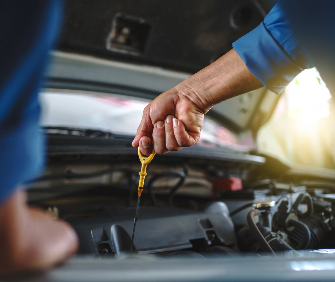 Checking car engine oil with dipstick.