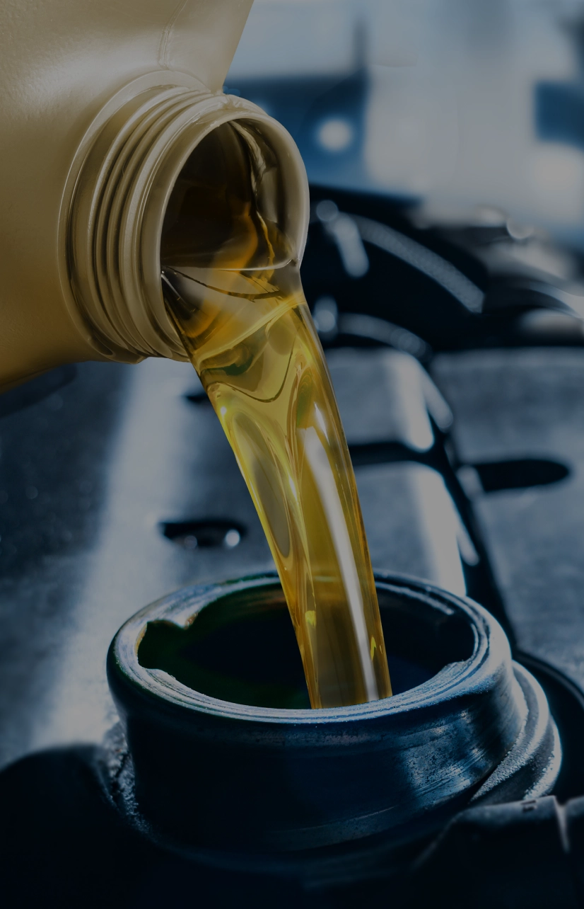 Pouring oil into a car engine.