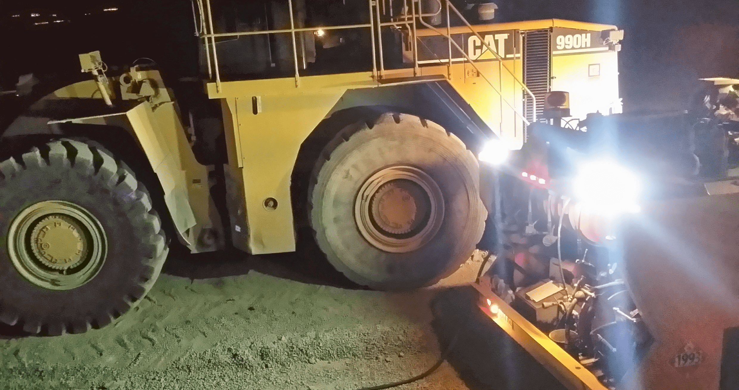 Construction vehicles working at night.