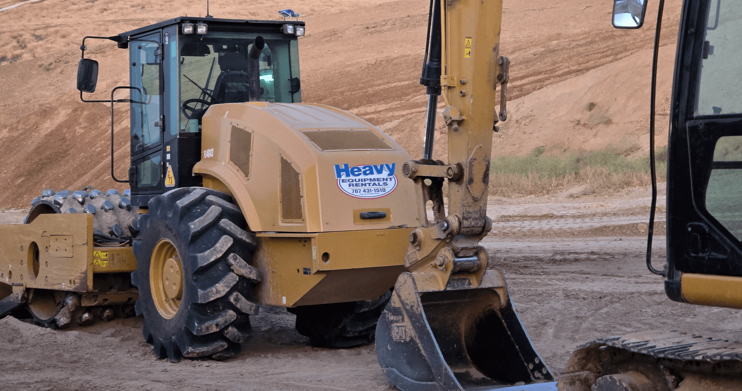 Construction vehicles on a dirt site.